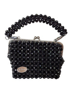 Black beaded handbag with a chain strap on a white background